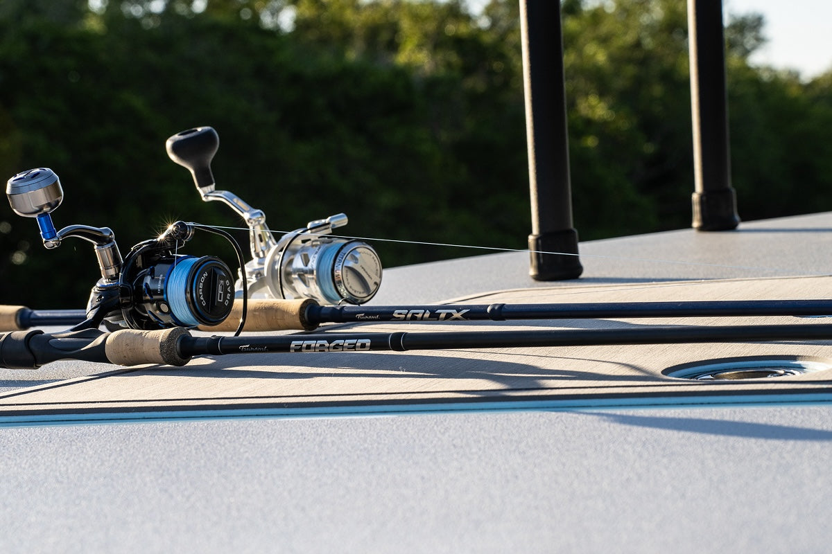 Fishing rod with reel on a boat deck with blurred background