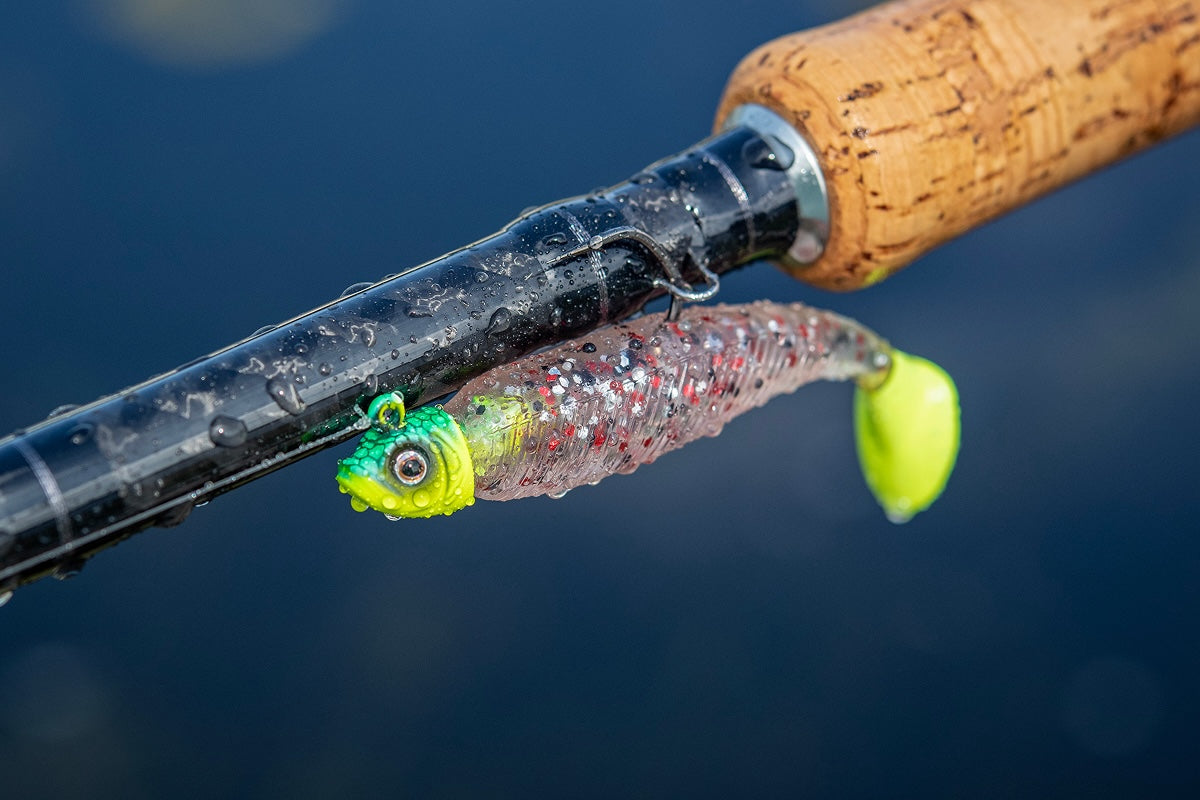Fishing lure attached to a fishing rod with a blurred blue background