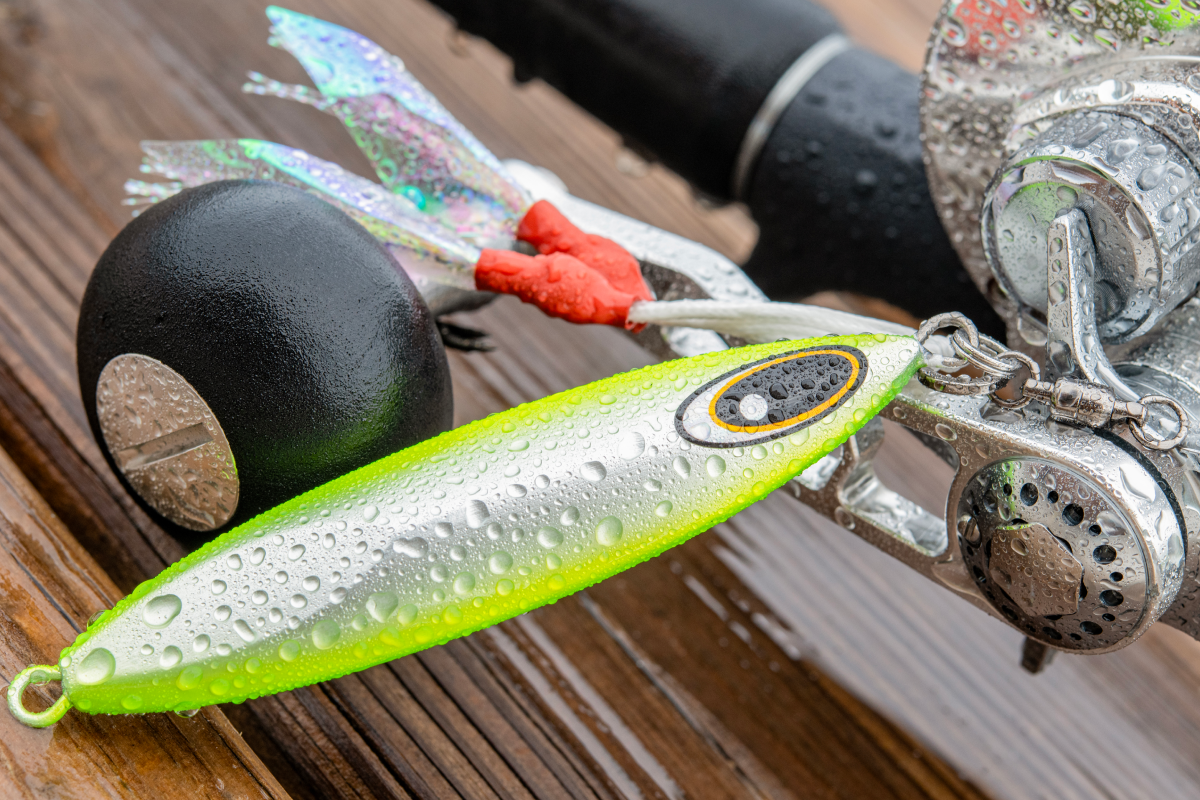 Fishing lure with fishing rod and reel on a wooden surface
